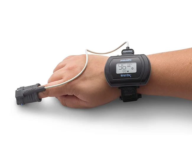 A person wearing the WristOx2, an overnight oximetry rental from high country oxygen in Breckenridge