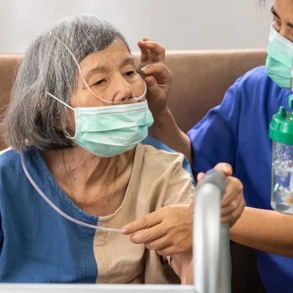 A patient has her nasal cannula adjusted while receiving medical oxygen rentals for post surgery recovery