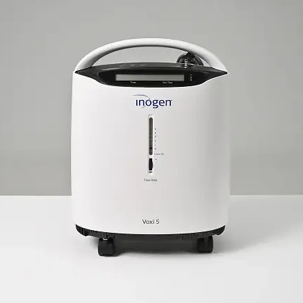Inogen Voxi 5 stationary oxygen concentrator with control panel and handle, designed for home oxygen therapy.